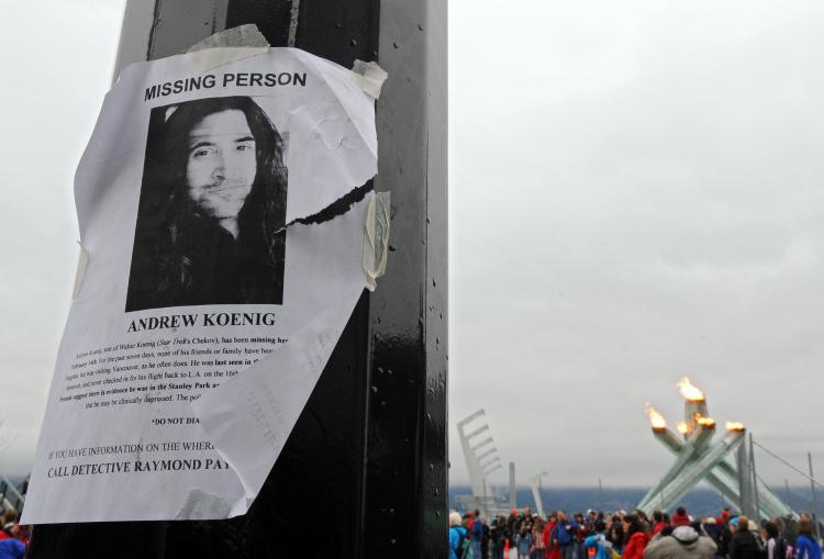 A missing persons poster for actor Andrew Koenig is seen on a light pole in front of the Olympic Cauldron in Vancouver. (Michael Heiman/Getty Images)