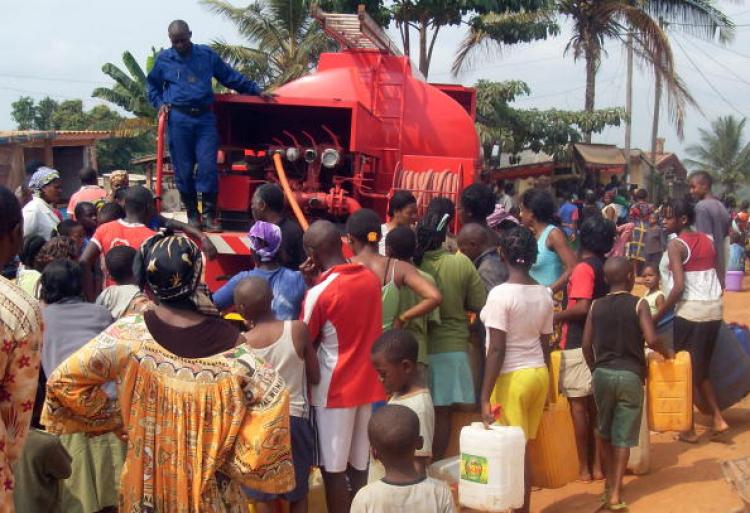 People wait as buckets and jerry cans are filled with water from a truck at a distribution point in Yaounde on February 21, 2010.  (STR/AFP/Getty Images)