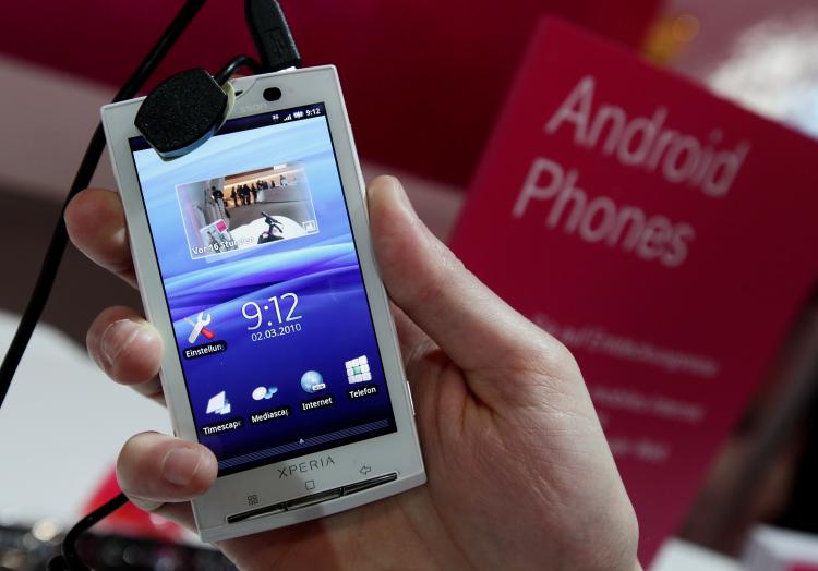 A stand host holds a Sony Ericsson XPERIA X10 mobile phone that uses the Android operating system at the Deutsche Telekom stand at the CeBIT Technology Fair on March 2, 2010 in Hannover, Germany. (Photo Illustration by Sean Gallup/Getty Images) A stand host holds a Sony Ericsson XPERIA X10 mobile phone that uses the Android operating system at the Deutsche Telekom stand at the CeBIT Technology Fair on March 2, 2010 in Hannover, Germany. (Photo Illustration by Sean Gallup/Getty Images)