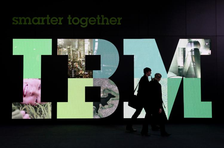 Visitors walk past the IBM logo at the CeBIT Technology Fair on March 3,in Hannover, Germany. IBM scientists are making a 3-D map of the Earth so small that 1,000 of them could fit on a grain of salt. (Sean Gallup/Getty Images)