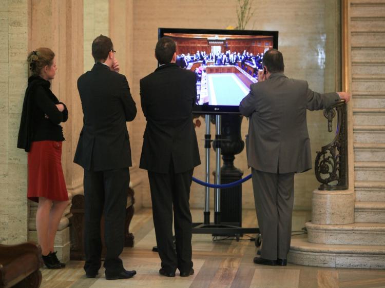 Workers watch the Northern Ireland Chamber proceedings at Stormont Parliament buildings in Belfast, Northern Ireland on March 9, 2010.  (Peter Muhly/AFP/Getty Images)