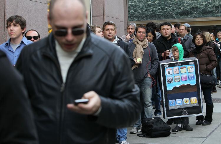 Lyle Haney (R) wears a iPad costume as he waits in line to purchase the new iPad at an Apple store Apr 3 in San Francisco, California. Hundreds of people lined up hours before the Apple store opened to purchase the new iPad which debuted today. (Justin Sullivan/Getty Images)