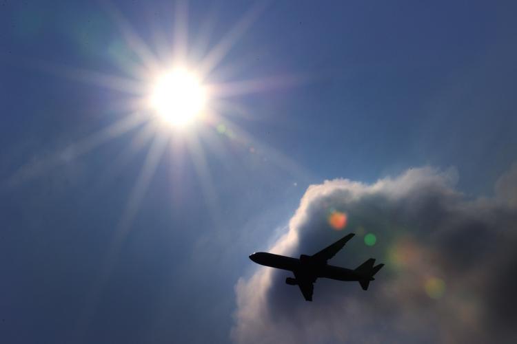 A passenger plane is seen shortly after takeoff at the Geneva international airport on March 11, 2010. The International Air Transport Association (IATA) said that global airlines are in line to earn a record-setting $15.1 billion in 2010.   (Fabrice Coffrini/Getty Images)