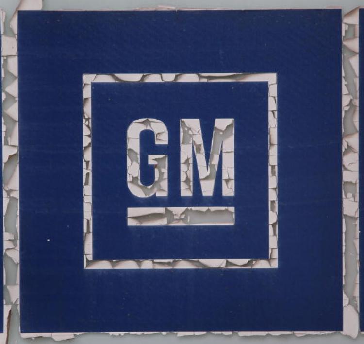 General Motors Co. (GM) logo on the door of a defunct auto parts store on April 7, 2010 in Chicago, Illinois. GM said that its second-quarter profits widened to $1.3 billion. (Scott Olson/Getty Images )