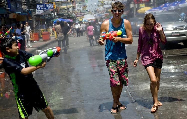 Foreign tourists and a Thai child duel with water guns along a tourist area of Bangkok on April 13 last year during the Songkran festival which marks the Thai New Year. (Manpreet Romana/AFP/Getty Images)