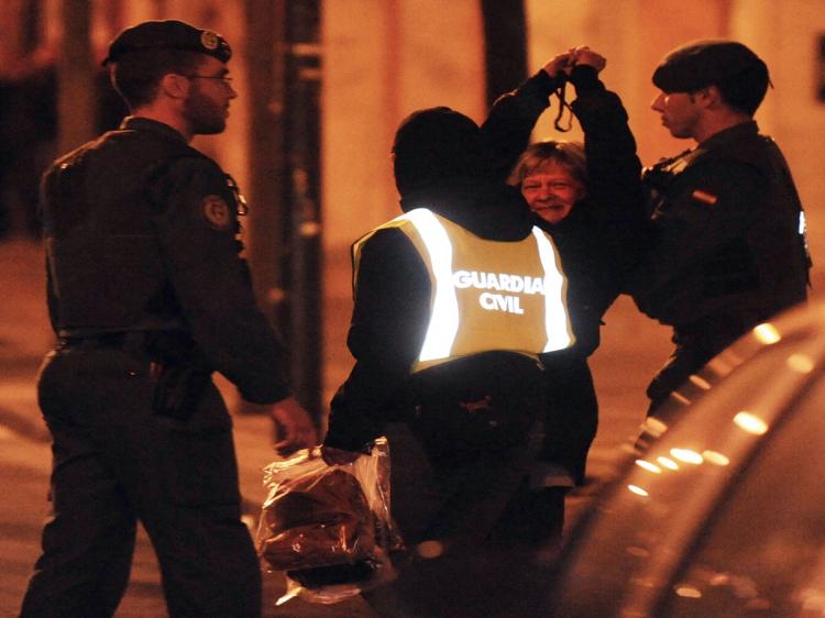 Lawyer Arantza Zulueta (2R) is arrested by Spanish Civil Guards on April 14, 2010, in the northern Spanish Basque city of Bilbao. Spanish police arrested at least five people, four of them Basque lawyers, on the orders of an anti-terrorist judge over their suspected links to the armed separatist group ETA, a court source said. (Rafa Rivas/AFP/Getty Images)