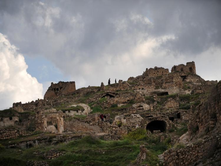 Visitors walk high on the ramparts of Hasankeyf a small poverty stricken town on the banks of the Tigris on April 10, 2010. Hasankeyf was once considered a mighty city in ancient Mesopotamia. Turkey has secured the support of a local bank to build a dam on a major historic site on the Tigris River, overriding harsh opposition at home and snubs by European lenders. (Bulent Kilic/AFP/Getty Images)