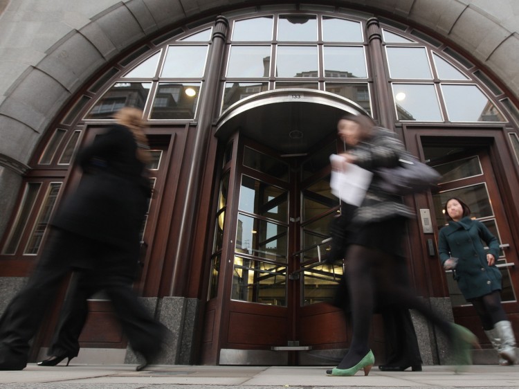 WAGES DEBATE: Employees are seen leaving the Goldman Sachs building in central London on Jan. 21, 2010. (Shaun Curry/AFP/Getty Images )
