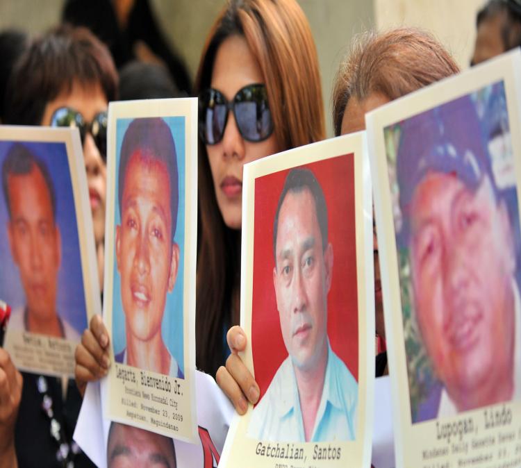 Relatives of the 37 journalists killed in the infamous Maguindanao massacre display portraits of their bereaved loved during a rally in front of the Department of Justice office in Manila in April. 21, 2010.  (Ted Aljibe/AFP/Getty Images)