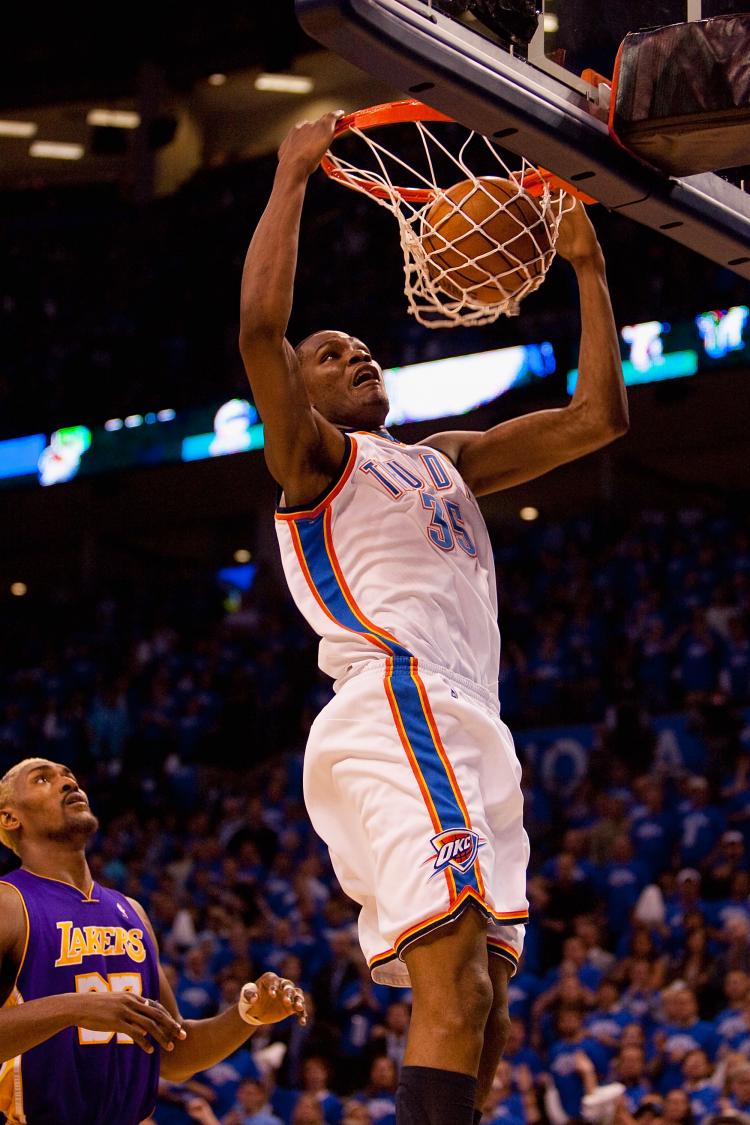 Kevin Durant of the Oklahoma City Thunder dunks the ball against Ron Artest of the Los Angeles Lakers during Game Three of the Western Conference Quarterfinals of the 2010 NBA Playoffs on April 22. (Dilip Vishwanat/Getty Images )