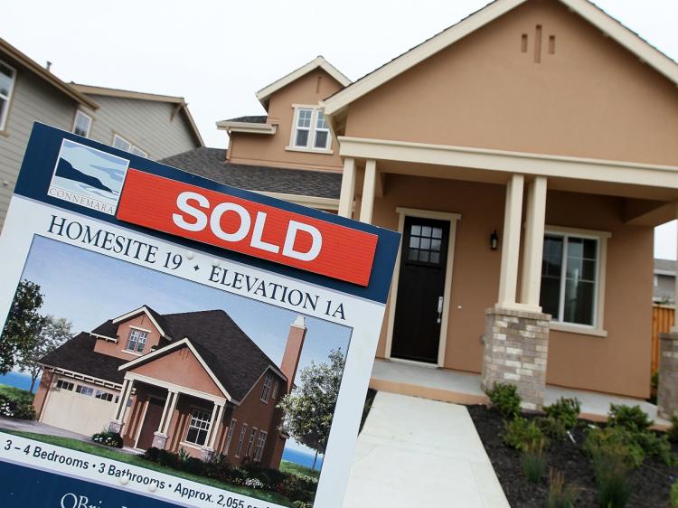 THINK POSITIVE: In this file photo from April, a sold sign is posted in front of a new home in a housing development. According to David J. Lynn, Ph.D., 2011 should see some positive growth for all sectors, which will continue to increase with each year of recovery (Justin Sullivan/Getty Images)