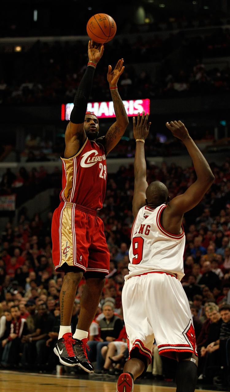 LeBron James #23 of the Cleveland Cavaliers puts up a three point shot over Luol Deng #9 of the Chicago Bulls on his way to a game-high 37 points in Game Four of the Eastern Conference Quarterfinals during the 2010 NBA Playoffs at the United Center on April 25, 2010. (Jonathan Daniel/Getty Images)