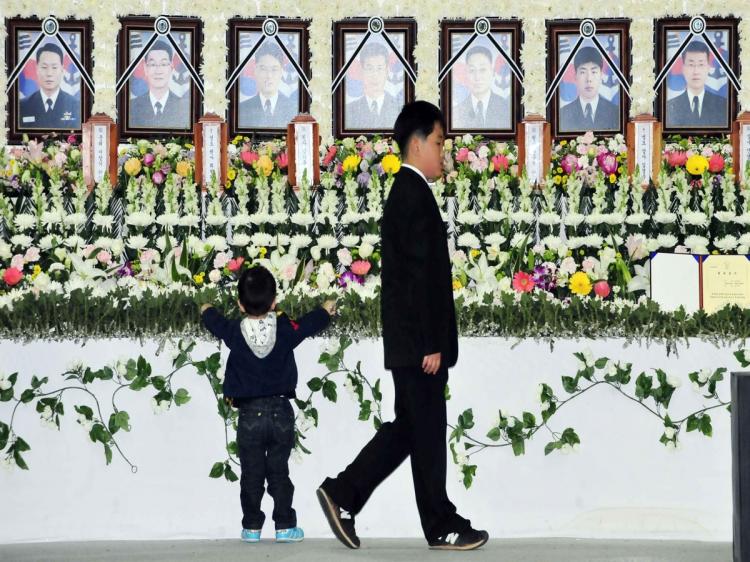 Two sons of the late Master Chief Petty Officer Nam Ki-Hoon visit a mourning altar at a naval base in Pyeongtaek on April 27, set up to pay tribute to sailors killed in the March 26 sinking of the warship PCC-772 Cheonan near the disputed border with Nort (Korea Pool/AFP/Getty Images)
