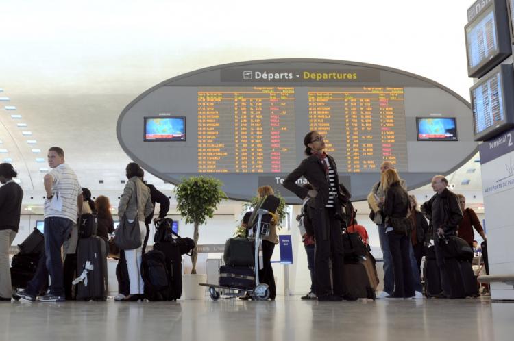 Passengers queue before boarding Air France flights on April 20 at the Charles de Gaulle airport in Paris. (Fred Dufor/AFP/Getty Images)