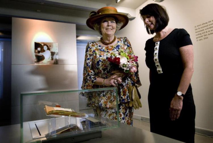 Dutch Queen Beatrix (L) and Teresien da Silva (R), head of collections of the Anne Frank Foundation, look at the original diaries of Anne Frank on April 28. It's the first time the works are exhibited. (Marcel Antonisse/Getty Images)