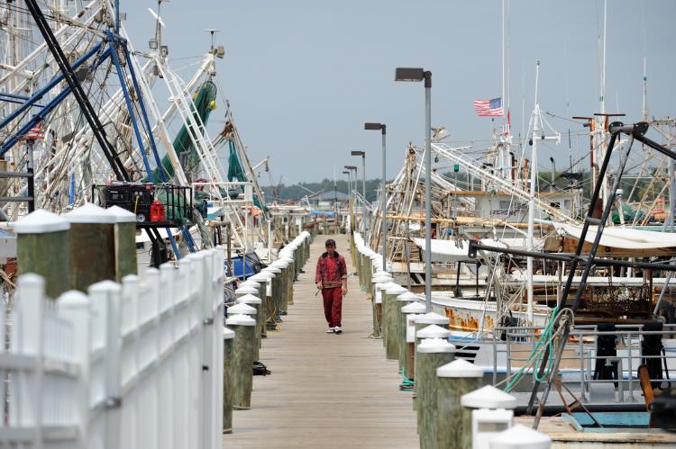 A fisherman walks on the dock past idle fishing boats on May 3, in Mississippi, as the fleet are confined to port since the shutdown of all fishing on the Gulf Coast due to the oil spill from the BP Deepwater Horizon disaster (Stan Honda/Getty Images)
