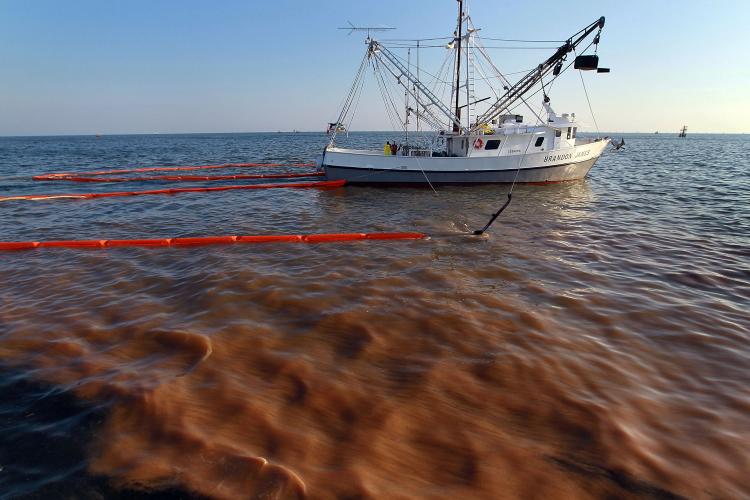 A shrimp boat passes through a heavy oil slick as it uses the deployed oil boom and absorption pads to collect the oil from the massive oil spill on May 5.  (Joe Raedle/Getty Images)