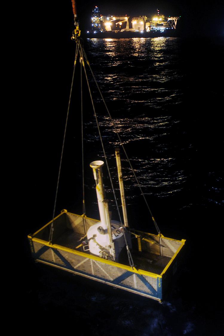 A small pollution containment chamber, known as the top hat, is lowered into water by the vessel Viking Poseidon May 11, in the Gulf of Mexico. The chamber is to be maneuvered over the leak on the seabed May 12, 2010 in an attempt to contain the BP oil sp (U.S. Coast Guard/Patrick Kelley via Getty Images)