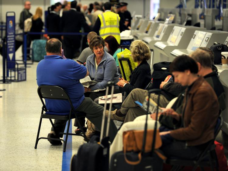 Passengers wait for information at Manchester Airport, in Manchester, after the airport was closed following a further disruption due to volcanic ash on May 16, 2010. Thousands of passengers were being re-routed on buses via other airports or having their flights canceled. (Paul Ellis/AFP/Getty Images)