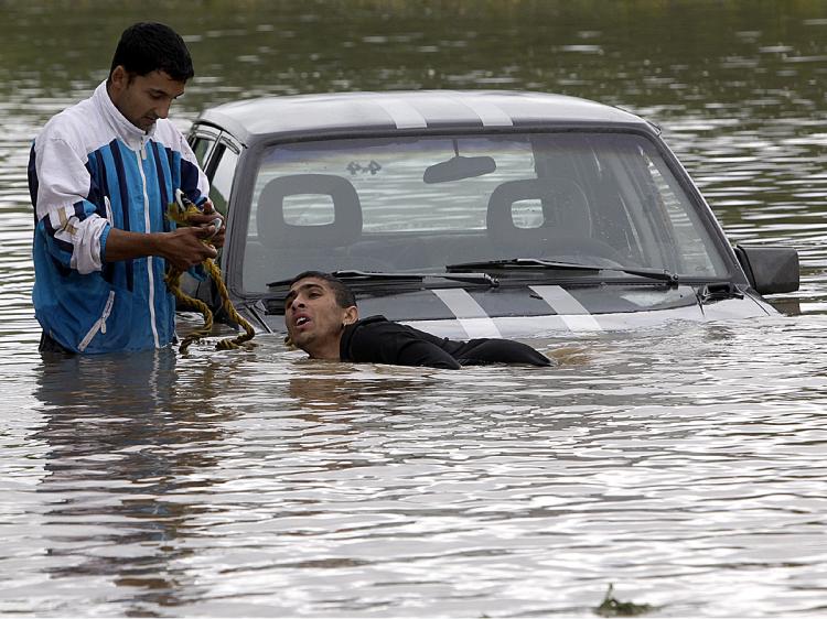 Residents try to salvage their car in the flood water of Vadasz stream near Alsovadasz village on May 17 as heavy rainfall and floods hit Hungary on the weekend. (Attila Kisbenedek/AFP/Getty Images)