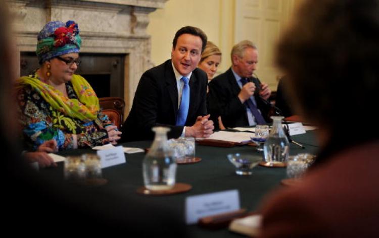 Founder of Kids Co, Camila Batmanghelidjh (L), attends the 'the Big Society' meeting, chaired by British Prime Minister, David Cameron, (C), in the cabinet room of 10 Downing Street in central London, on May 18, 2010. (Ben Stansall/AFP/Getty Images))