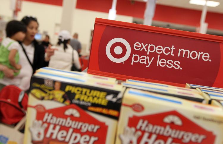 EXPANDING NORTH: A sign is posted next to sales items at a Target last year in Daly City, Cali. Target announced on Thursday that it had purchased 220 Zellers stores in Canada, which it would convert into Target starting in 2013.