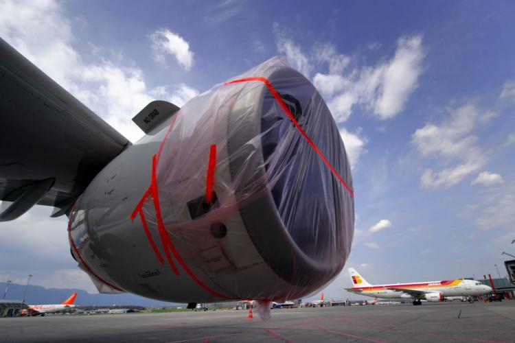 An aircraft with its engines covered with plastic protection is parked in front of the control tower at Cointrin Geneva's International Airport, on April 18, as planes are grounded following the volcanic eruption in Iceland. Switzerland extended a ban on commercial flights at its airports until Monday. (Fabrice Coffrini/AFP/Getty Images)