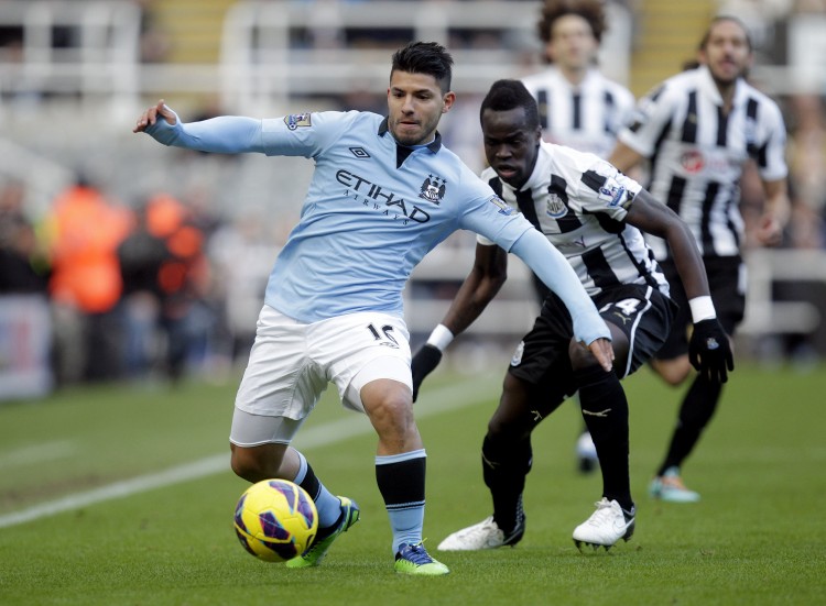Manchester City's Sergio Aguero fends of Newcastle's Cheik Tiote in English Premier League action on Saturday, Dec. 15, 2012. (Graham Stuart/AFP/Getty Images)