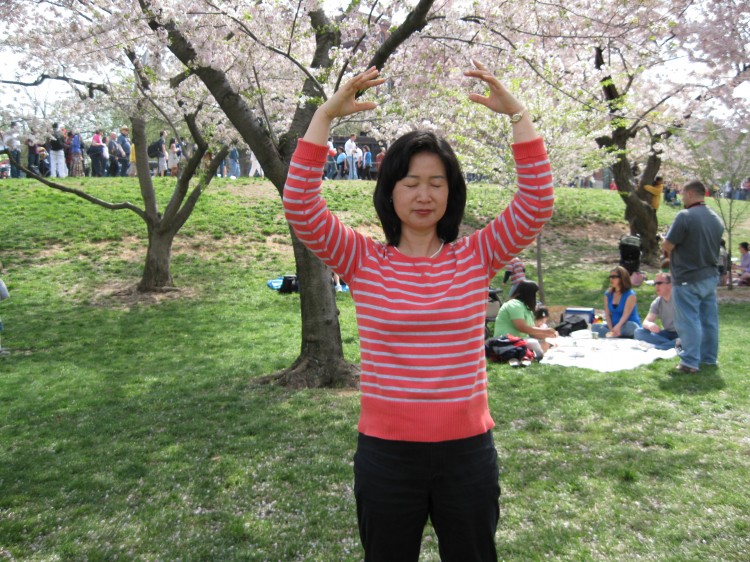 Cui Aidong, Cui Aimin's sister, practices one of the Falun Gong