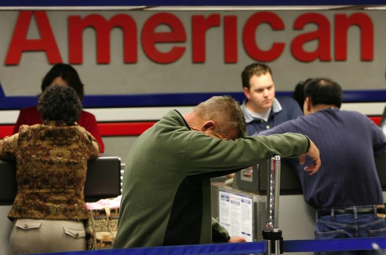 Passengers are seen waiting in line at the Dallas Fort Worth International Airport in Irving, Texas. An airline industry group projected fewer travelers this Labor Day weekend due to higher airfares. (Rick Gershon/Getty Images)