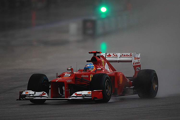 Fernando Alonso of Ferrari drives through the rain on his way to winning the Formula One Malaysian Grand Prix. (Mark Thompson/Getty Images)