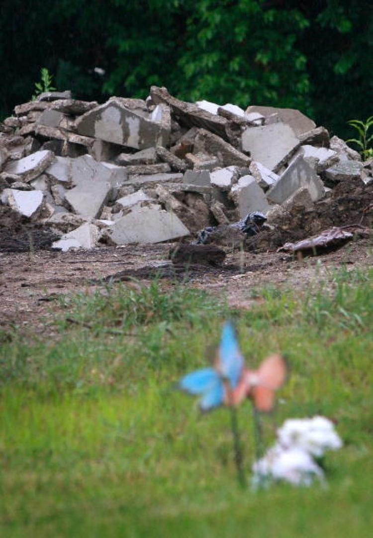 A pile of stone, which police say is made up of broken-up burial vaults and headstones, sits near a grave in Burr Oak Cemetery. Four employees were reselling plots. (Scott Olson/Getty Images)