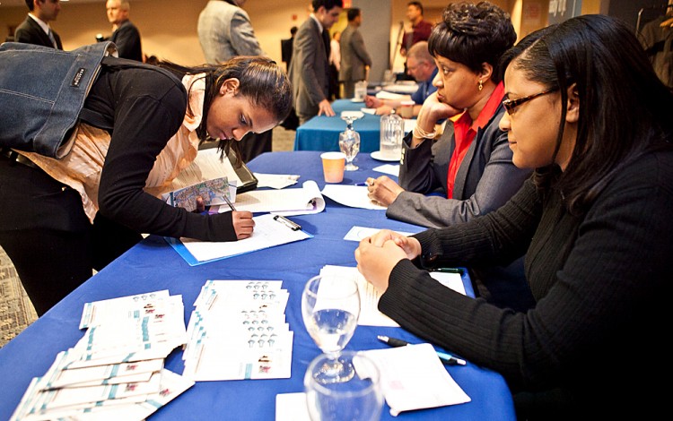 A woman fills out an employment form at a job fair in Midtown Manhattan