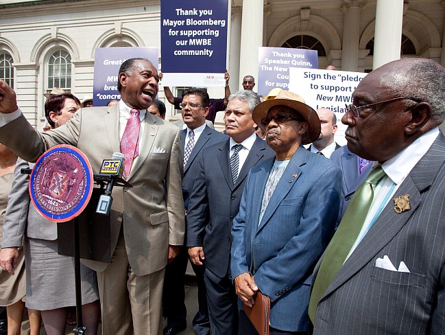 Reverend Jacques De Graff speaks Wednesday at a rally to support a proposed city legislation to expand city contracts for women-owned and minority emerging business enterprises. (Amal Chen/The Epoch Times)