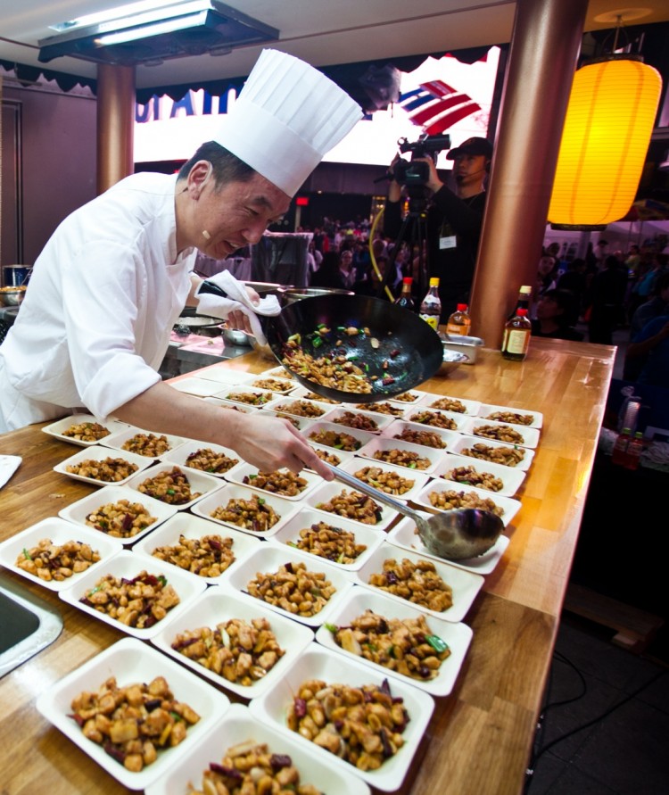 Last year's gold medal winner Jiang Rong Yi serves up authentic Chinese cuisine at the Fourth Annual International Chinese Culinary Competition, being hosted by the New Tang Dynasty (NTD) Television in Times Square on Thursday and Friday.  (Amal Chen/The Epoch Times)