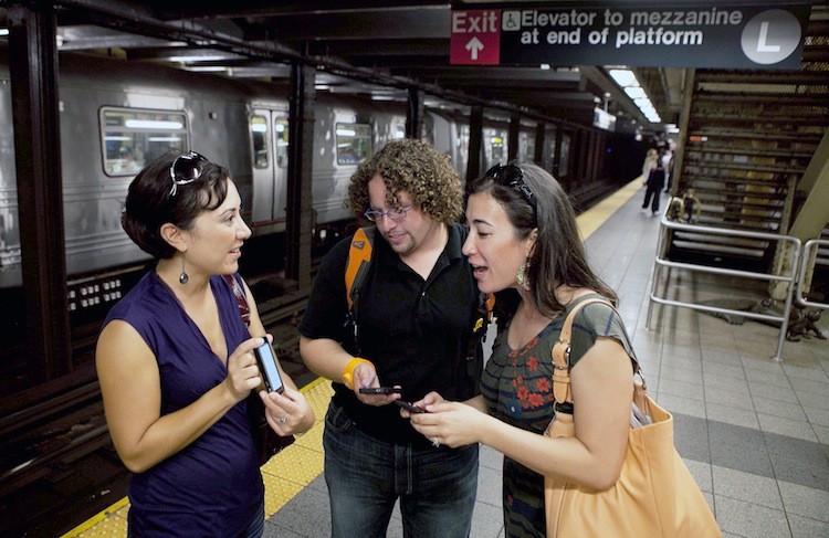 Kirsten Mickelson (R) of San Francisco, Ben Abo (C) of New Jersey, and Amy Coren of Washington D.C. try out the new underground wireless service announced on Tuesday.  (Amal Chen/The Epoch Times)