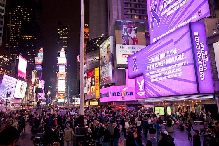 Times Square billboards turn purple Wednesday night in honor of Domestic Violence Awareness Month.  (Amal Chen/The Epoch Times)