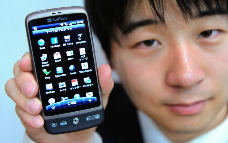 An employee of Japan's mobile communications operator Softbank introduces the company's new smartphone called 'HTC Desire' during a press preview in Tokyo on March 28. (Toru Yamanaka/AFP/Getty Images)