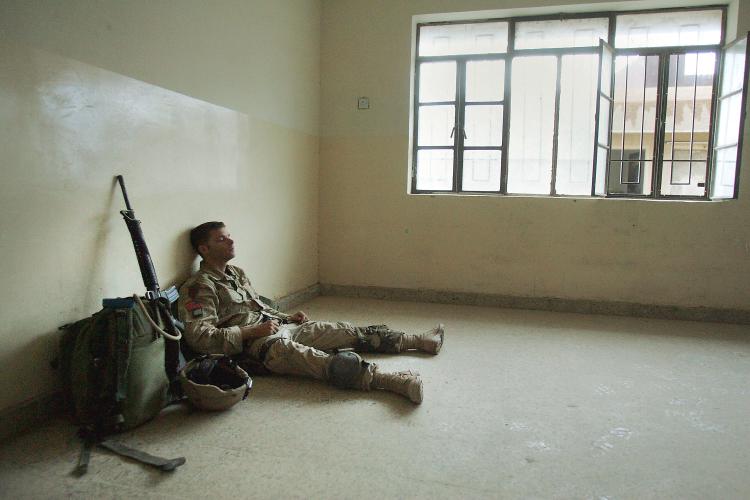 An exhausted U.S. Army soldier takes a short break after engaging enemy forces all night during heavy fighting in Fallujah, Iraq, in this file photo.  (Scott Nelson/Getty Images)