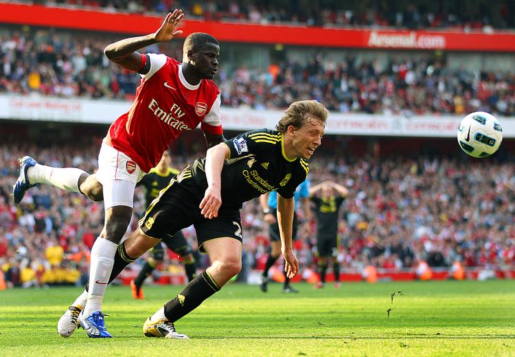 PENALIZED: Arsenal's Ivorian midfielder Emmanuel Eboue (L) collides with Liverpool's Brazilian player Lucas Leiva (2nd L) to concede a last-minute penalty during the Premiership football match at the Emirates. (Adrian Dennis/AFP/Getty Images)