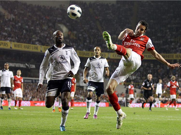 Arsenal's Robin Van Persie goes airborne while taking a shot against Tottenham Hotspur in Wednesday's North London derby. (Adrian Dennis/AFP/Getty Images)