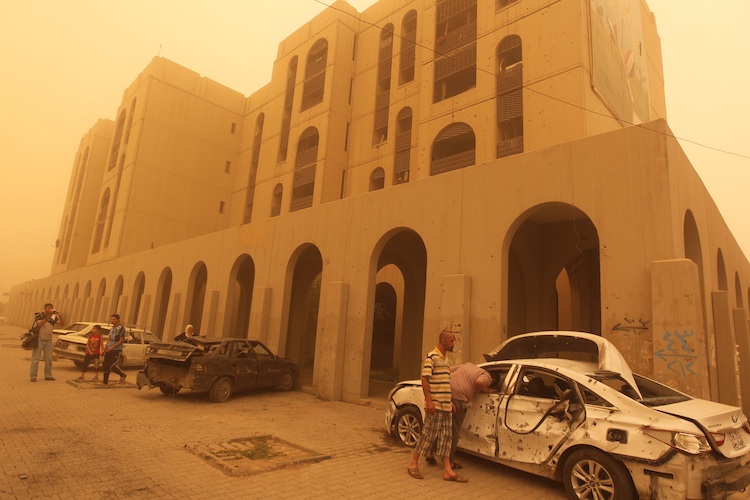 Iraqis inspect after car bomb in Baghdad