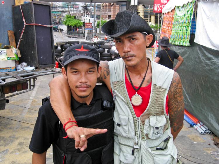 Anti-government protesters behind the camp's barricades, which is situated in one of Bangkok's ritziest shopping districts. (The Epoch Times)