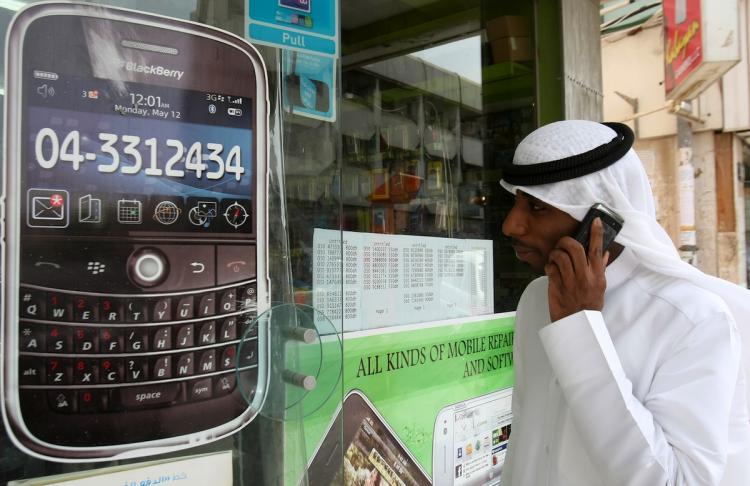 A man walks past a sign advertising the BlackBerry mobile phone at a shopping mall in Dubai on August 01. As the Gulf business hub stated it will suspend key BlackBerry services from October because they are incompatible with local laws and raise security issues.  (STR/Getty Images)