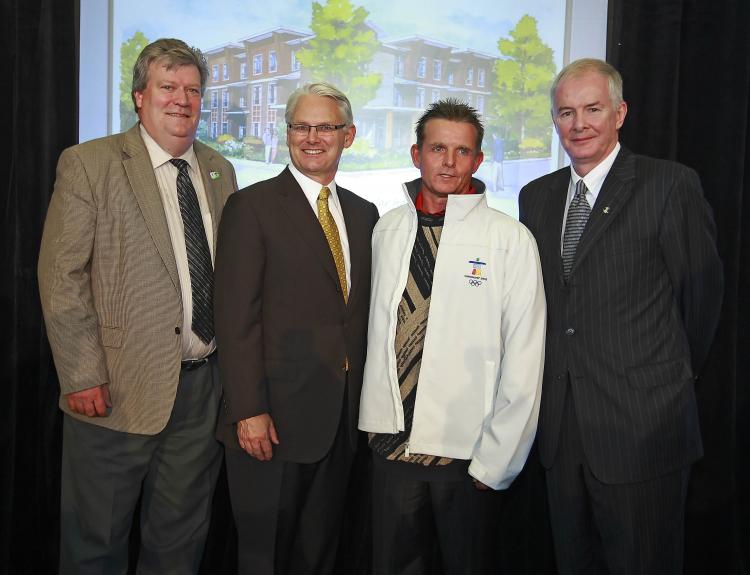 VANOC and the Province of B.C. plan to convert Olympic modular units into affordable homes after the Games. (L-R) Housing Minister Rich Coleman, Premier Gordon Campbell, Mark from Phoenix Drug and Alcohol Centre, and VANOC CEO John Furlong.  (B.C. Housing)
