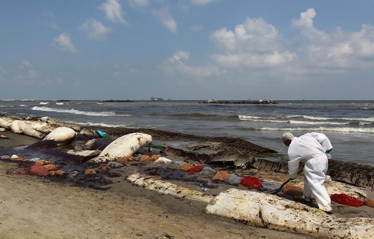 A BP cleanup crew removes oil from a beach on May 23, at Port Fourchon, Louisiana. Officials now say that it may be impossible to clean the hundreds of miles of coastal wetlands affected by the massive oil spill which continues gushing in the Gulf of Mexico. (John Moore/Getty Images)