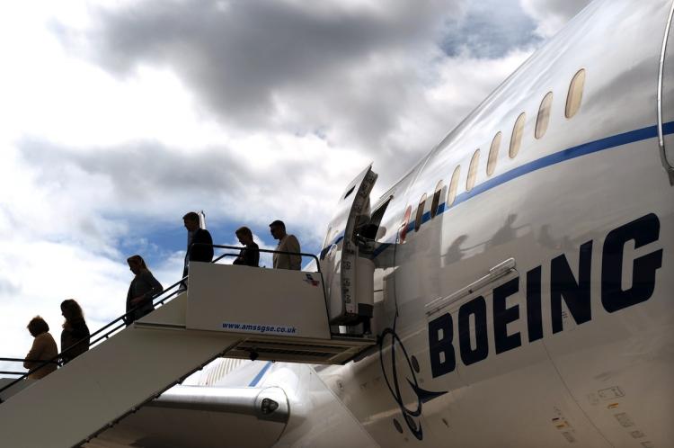 NEW AIRCRAFT: Guests exit a Boeing 787 Dreamliner aircraft at the Farnborough Air Show in Hampshire, England on July 18. Aerospace giant Boeing Co. said that it might delay to 2011 the delivery of the first 787 Dreamliner aircraft scheduled at the end of this year.  (Ben Stansall/Getty Images)