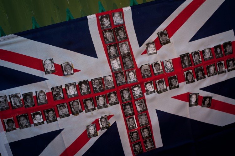 An Australian flag made up of photographs of victims of the 2002 bomb blast is seen on a fence at the site of the Sari Club in Jalan Legian, Bali, on Oct. 10, 2012. Many relatives and foreign tourists have begun to arrive to take part in ceremonies marking the 10th anniversary of the bomb attack in the Kuta tourist district. (Chris McGrath/Getty Images) 