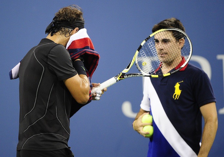 IMPORTANT JOB: Spanish tennis player Rafael Nadal wipes his face while a ball boy awaits to give him a ball at the 2010 US Open tennis. (Emmanuel Dunand/Getty Images) IMPORTANT JOB: Spanish tennis player Rafael Nadal wipes his face while a ball boy awaits to give him a ball at the 2010 US Open tennis. (Emmanuel Dunand/Getty Images)