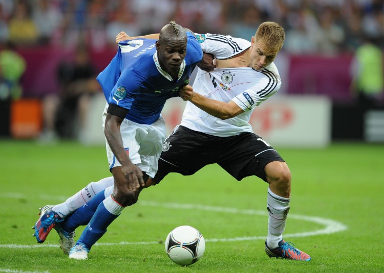 Italy's Mario Balotelli and Germany's Holger Badstuber vie for the ball in Euro 2012 semifinal action on Thursday in Warsaw. (Christopher Lee/Getty Images)